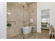 Luxurious bathroom featuring a modern soaking tub and tiled walls with a glass enclosed shower at 12638 E Cortez Dr, Scottsdale, AZ 85259