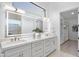 Bright bathroom with a double vanity, marble countertops, and modern lighting fixtures at 12638 E Cortez Dr, Scottsdale, AZ 85259