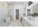 Bright bathroom featuring a soaking tub, glass shower, marble countertop, and white cabinets at 12638 E Cortez Dr, Scottsdale, AZ 85259