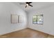 Bright and airy bedroom with wood floors, a ceiling fan, and a large window at 12638 E Cortez Dr, Scottsdale, AZ 85259