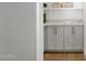 Charming butler pantry with bright countertop and grey cabinetry at 12638 E Cortez Dr, Scottsdale, AZ 85259