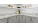 Charming butler pantry with bright countertop, grey cabinetry and open shelving at 12638 E Cortez Dr, Scottsdale, AZ 85259