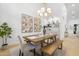 Dining room with a wooden table, bench seating, designer light fixture, and modern art at 12638 E Cortez Dr, Scottsdale, AZ 85259