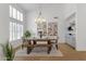 Bright dining room with modern chandelier and view of the wet bar at 12638 E Cortez Dr, Scottsdale, AZ 85259