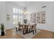 Bright dining room with modern chandelier, two paintings and lots of natural light at 12638 E Cortez Dr, Scottsdale, AZ 85259