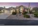 Stunning home exterior featuring manicured landscaping, a three-car garage, and desert flora at 12638 E Cortez Dr, Scottsdale, AZ 85259