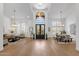 Expansive foyer with high ceilings, grand chandelier, and hardwood floors flowing into the dining and living areas at 12638 E Cortez Dr, Scottsdale, AZ 85259