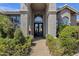 Stately home featuring an arched entrance with double doors and lush landscaping at 12638 E Cortez Dr, Scottsdale, AZ 85259