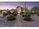 Elegant home with a stone pathway, manicured landscaping, and a striking cactus, creating a welcoming entrance at 12638 E Cortez Dr, Scottsdale, AZ 85259
