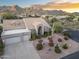 Attractive home with a well-maintained front yard, a wide driveway, and stunning mountain views in the background at 12638 E Cortez Dr, Scottsdale, AZ 85259