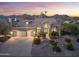 Beautifully landscaped home with mountain views, featuring a three-car garage and a spacious driveway at 12638 E Cortez Dr, Scottsdale, AZ 85259