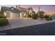 Spacious home with a large driveway, three-car garage, and beautifully landscaped front yard at 12638 E Cortez Dr, Scottsdale, AZ 85259