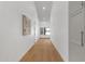 Long hallway with white walls, wood flooring and recessed lighting leading to various rooms at 12638 E Cortez Dr, Scottsdale, AZ 85259