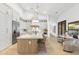 Bright kitchen featuring an island with marble countertop, pendant lighting, and stainless steel appliances at 12638 E Cortez Dr, Scottsdale, AZ 85259