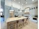 Gourmet kitchen with island, stainless fridge, stone countertops, and light fixtures at 12638 E Cortez Dr, Scottsdale, AZ 85259