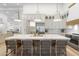 Bright kitchen featuring an island with marble countertop, pendant lighting, and seating at 12638 E Cortez Dr, Scottsdale, AZ 85259