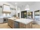 Bright kitchen featuring an island with marble countertop, pendant lighting, and stainless steel appliances at 12638 E Cortez Dr, Scottsdale, AZ 85259