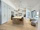 Well-lit open kitchen with large island, ample storage, stainless appliances, and seating for entertaining at 12638 E Cortez Dr, Scottsdale, AZ 85259