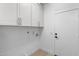 Bright laundry room with white cabinets and ample storage space at 12638 E Cortez Dr, Scottsdale, AZ 85259