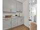 Laundry room with marble countertops, cabinets, and an open doorway at 12638 E Cortez Dr, Scottsdale, AZ 85259