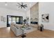 Bright living room with fireplace, access to the pool and modern ceiling fan at 12638 E Cortez Dr, Scottsdale, AZ 85259