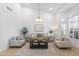 Bright living room featuring a neutral palette, high ceilings, stylish decor and large windows with plantation shutters at 12638 E Cortez Dr, Scottsdale, AZ 85259