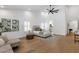 Beautifully staged main bedroom with a seating area, ceiling fan, and light hardwood flooring at 12638 E Cortez Dr, Scottsdale, AZ 85259