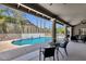 Covered patio with seating overlooks the pool area with columns and landscaping at 12638 E Cortez Dr, Scottsdale, AZ 85259