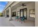 Covered patio with seating, a ceiling fan and views of the pool and backyard at 12638 E Cortez Dr, Scottsdale, AZ 85259