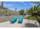 Relaxing patio featuring lounge chairs, privacy wall, and lush landscaping at 12638 E Cortez Dr, Scottsdale, AZ 85259