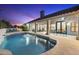 Relaxing outdoor pool area with covered patio, elegant columns, and desert landscaping at 12638 E Cortez Dr, Scottsdale, AZ 85259
