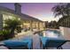 Backyard pool with comfortable loungers and beautiful twilight sky at 12638 E Cortez Dr, Scottsdale, AZ 85259