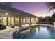 Sparkling swimming pool and spa with lounge chairs at twilight at 12638 E Cortez Dr, Scottsdale, AZ 85259
