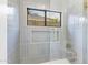 Shower-tub combo with blue tile, glass door, and view to the outside at 12638 E Cortez Dr, Scottsdale, AZ 85259