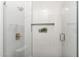 Tiled walk-in shower with glass door and built-in niche at 12638 E Cortez Dr, Scottsdale, AZ 85259