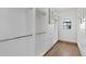 This walk-in closet has custom shelving, cabinets, drawers and hanging rods for optimal organization at 12638 E Cortez Dr, Scottsdale, AZ 85259
