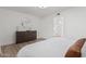 Bright bedroom with dresser, mirror, and view into bathroom at 13237 N 25Th Dr, Phoenix, AZ 85029