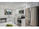 Updated kitchen with white cabinets, modern appliances, and stone countertops at 13237 N 25Th Dr, Phoenix, AZ 85029