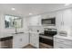 Modern kitchen features stainless steel appliances, quartz counters, and window at 13237 N 25Th Dr, Phoenix, AZ 85029