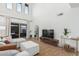Open concept living area with modern furnishings, tall windows, and access to the outdoor area at 13237 N 25Th Dr, Phoenix, AZ 85029