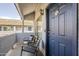 Cozy balcony featuring seating and a view, adjacent to the unit's entrance door at 1331 W Baseline Rd # 360, Mesa, AZ 85202