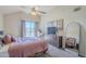 Bright bedroom with a ceiling fan, a large window, a dresser, and a full-length mirror at 1331 W Baseline Rd # 360, Mesa, AZ 85202