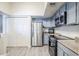 Kitchen boasts stainless steel appliances, ample storage, and bright countertops for a clean look at 1331 W Baseline Rd # 360, Mesa, AZ 85202