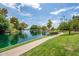 Picturesque lake view with a serene path, lush greenery, and clear skies at 1331 W Baseline Rd # 360, Mesa, AZ 85202