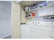 Practical laundry room with white appliances and ample shelving for storage at 1331 W Baseline Rd # 360, Mesa, AZ 85202