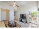 Comfortable living room with a ceiling fan, a television, and closet access at 1331 W Baseline Rd # 360, Mesa, AZ 85202