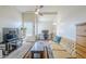 Bright living room with a ceiling fan, a desk, and a comfortable yellow sofa at 1331 W Baseline Rd # 360, Mesa, AZ 85202