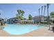 Large community pool with clear blue water, surrounded by lounge chairs and landscaping at 1331 W Baseline Rd # 360, Mesa, AZ 85202