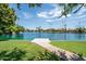 Scenic waterfront view of the community lake, featuring a private dock and lush landscaping at 1331 W Baseline Rd # 360, Mesa, AZ 85202