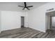 Spacious bedroom with ceiling fan, wood-look floors, and white walls at 1351 N Pleasant Dr # 2011, Chandler, AZ 85225